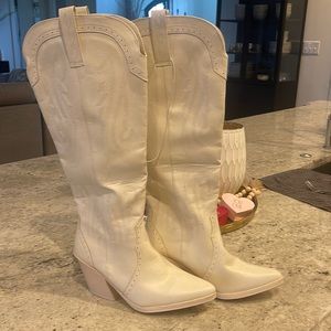 Creamy white tall cowboy boots.